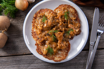 Tasty homemade potato pancakes with meat and mushrooms