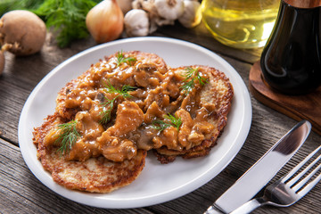 Tasty homemade potato pancakes with meat and mushrooms