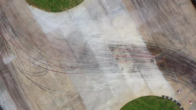 Drifting car, Aerial view from flying drone of a professional driver drifting car on race track, Race drift car with lots of smoke from burning tires on speed track, 4k