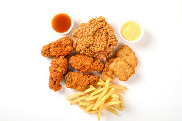 Crispy Fried chicken and frech fries with nuggets,sauce isolated on white background. Top view