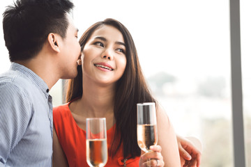 Adult asian lover couple man and woman hand hold a champagne.