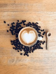 cup of coffee and beans on wooden table