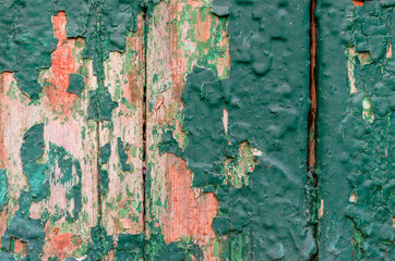 Old wooden surface with peeling green paint