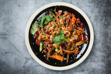 This is a dry pot cooking in Chengdu, Sichuan Province. It's made of octopus tentacles and a variety of chili peppers mixed with beef. Local traditions are only for real men to enjoy.