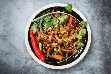 This is a dry pot cooking in Chengdu, Sichuan Province. It's made of octopus tentacles and a variety of chili peppers mixed with beef. Local traditions are only for real men to enjoy.