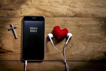 Bible app in smart phone, symbol of christian is love and read and listen to the voice of God,...