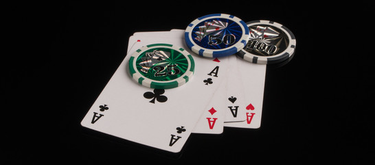 Poker chips and cards on a black background. The concept of gambling and entertainment. Casino and poker