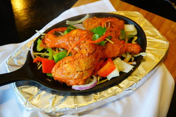A dish of grilled chicken tandoori at an Indian restaurant