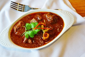 A dish of red goat curry at an Indian restaurant
