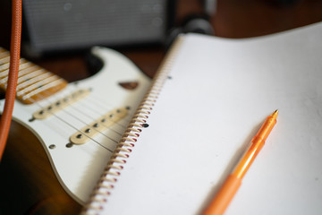 Notebook and pen with electric guitar