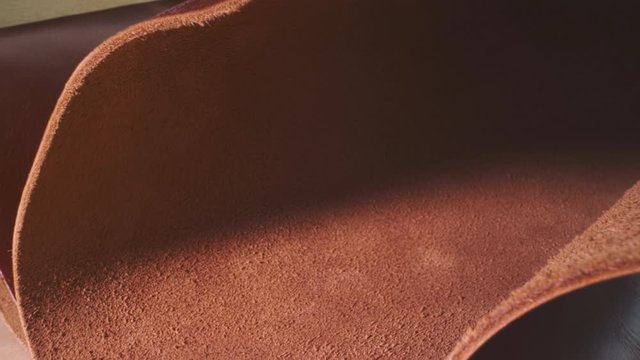 Natural Brown leather texture in macro close up with a sliding camera move background.