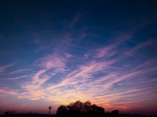 sunset in the sky with blue and pink sun lightning