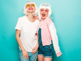 Two young sexy hipster girls in white wigs and red lips.Beautiful trendy women in summer...