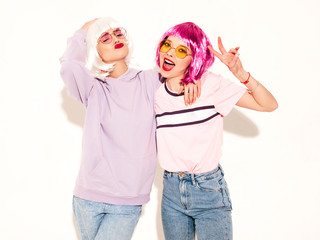 Two young sexy hipster girls in wigs and red lips.Beautiful trendy women in summer clothes.Carefree...