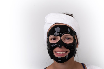 Portrait of a cheerful woman with a shiny black mask on her face