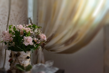 Home large and cozy window from which bright light passes into the room. Apartment fabric interior. Colored and transparent curtains with openwork pattern.