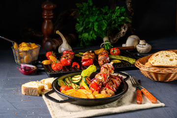 Fototapeta na wymiar Shish kebab with various vegetables and spice country potatoes