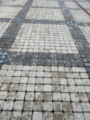wet track paved with gray curly tiles