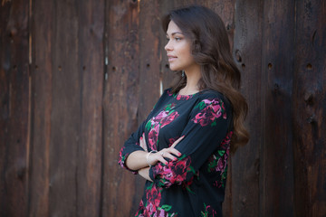 Portrait of beautiful young girl on wooden background.