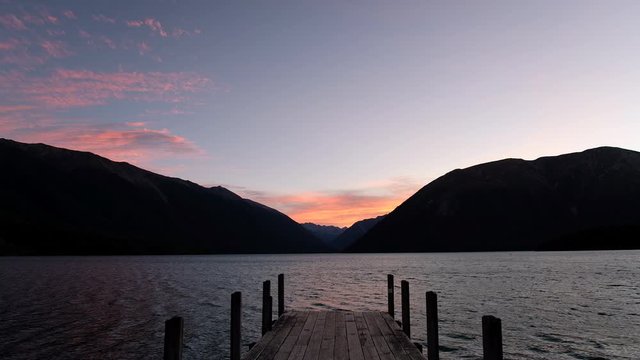 The sunset scene at lake, Silhouette Wooden Jetty, mountain view.