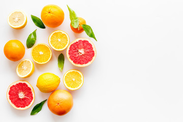 Fresh citrus frame. Oranges, tangerines, grapefruits, leaves on white background top-down copy space