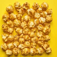 flat lay popcorn on a bright yellow background. Top view