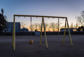 An empty playground at an elementary school in Japan during sunset.