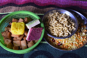 Indian breakfast milk sweets and snacks colorful cloth in the background