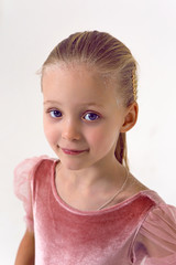 gymnast girl in pink velvet bodysuit stands in Studio
