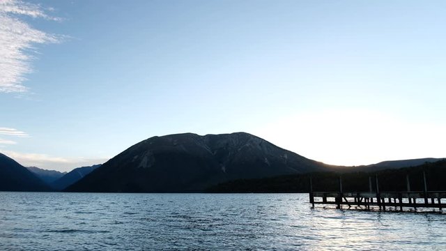 The sunset scene at lake, Silhouette Wooden Jetty, mountain view.