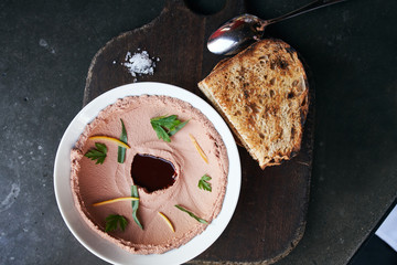 Top Down View of Smoked Chicken Liver Pate Served on a Round Plate with Bread