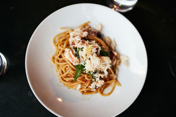 Top View of Gourmet Spaghetti with Crab Meat Served on a round white plate
