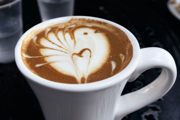 Latte Served on a white mug with Bird Latte Art in dark background 