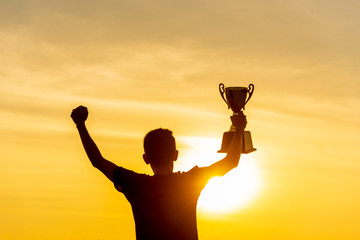 Winner win holding golden champion trophy cup prize. Silhouette best award victory trophy for...