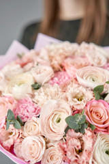 Closeup beautiful bouquet of mixed flowers. Work of the florist at a flower shop. Delivery fresh cut flower. European floral shop.