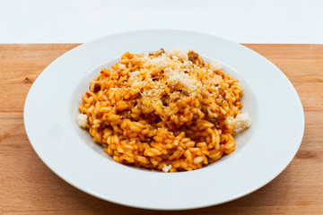 Traditional italian risotto with bolognese ragu and parmigiano reggiano cheese