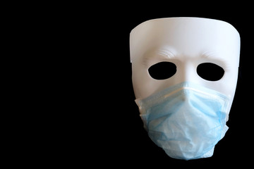 Isolated photo of blue infection preventive face mask on demonstrated white plastic mask and space for write wording. Important tools for protecting people from virus distribution in crisis 2020