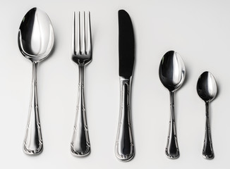 Set of silver cutlery on a white background