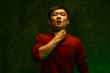 Coronavirus infected Chinese man suffocating. Close up portrait