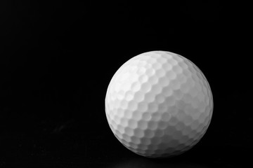 Golf ball close up on black background