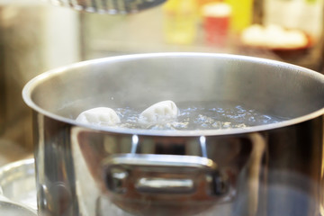 Khinkali boiling in a stainless steel cooking pot