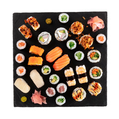 Large sushi set, isolated on a white background with a clipping path, shot from the top. A flat lay of various maki, nigiri and rolls