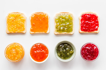 Toast with jam pattern on white background flat lay