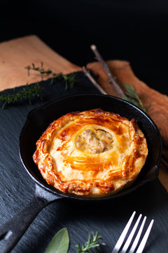 Food Concept Homemade Golden Meat Puff Pastry Pie In Skillet Iron Cast On Black Slate Board With Copy Space