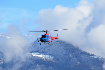 Fototapeta na wymiar Helicopter Flying over Snow-capped Mountain in Switzerland.