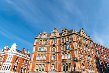 Fototapeta na wymiar Old residential buildings in the city of London against blue sky