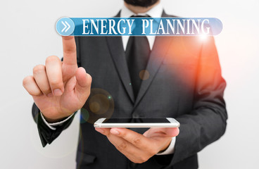 Word writing text Energy Planning. Business photo showcasing making of a strategy and plan for the consumption of energy Male human wear formal work suit hold smart hi tech smartphone use one hand