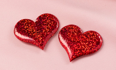 Two red hearts for Valentine's Day On a pink background