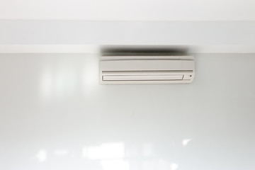 Air conditioning Installed on a white concrete wall in the house.