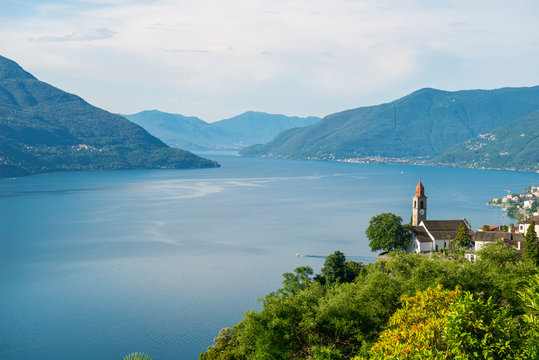 Church over Alpine Lake Maggiore with Mountain in Ronco sopra Ascona, Switzerland.
